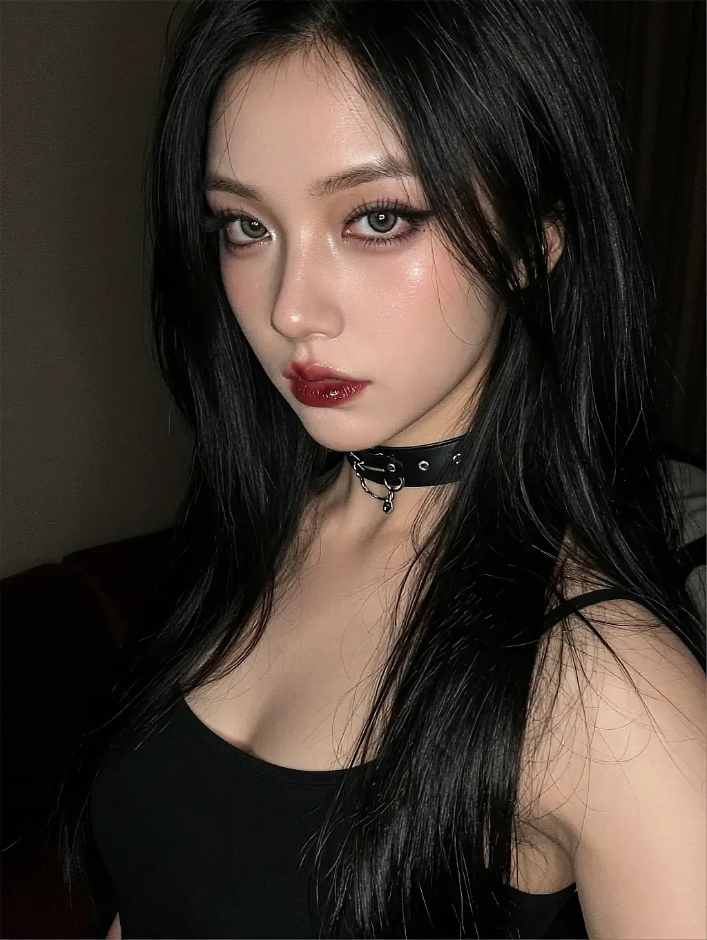 Fictional AI character with black hair, dark lipstick and a choker, photographed close in low light